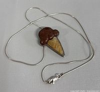Photo of the 925 silver necklace with an ice cream cone pendant showing chain and clasp.
