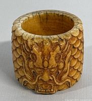 Front view clearly showing the dragon face carving on the ring.