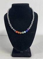 Full view of the necklace displayed on black bust showing the bead arrangement and clasp.