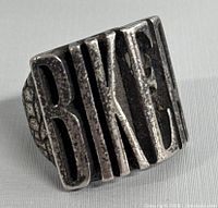 Front view of vintage biker ring showing raised 'BIKER' lettering.
