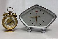Both clocks side-by-side, showing size and style differences