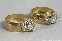 Pair of wild cat hoop earrings displayed side by side