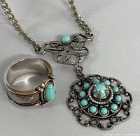 Photo of turquoise ring and necklace side by side showing style and stone details