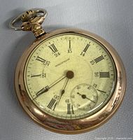 Front view of Waltham pocket watch showing Roman numeral dial, subdial seconds, and winding crown.