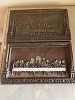 Two Syroco Last Supper 3-D wall plaques, one in brown tone and one in color, stacked vertically showing full plaques.