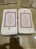 Two sealed original styrofoam packages each containing a Promise Bear sculpture certificate, titles Faith and Giving, numbered artworks from The Hamilton Collection.