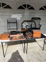 Overview of vintage wooden decorative items on tables, including shelves, boxes, trays, and framed florals.