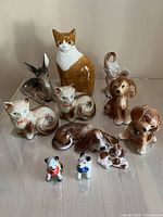 Full view showing all porcelain ceramic animal figurines including cats, dogs, deer, and elephant.