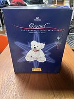 Front view of the original Swarovski crystal teddy bear box showing branding, product name, and size (11 inches)