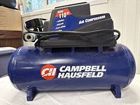 Full view of the blue Campbell Hausfeld air compressor with logo and black motor housing showing the power cord wrapped around the unit.