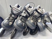 Two pairs of Airwalk rollerblades in grey and black with white mesh. One pair size 9 women's, the other size 10 men's, shown from front, side, and back angles.