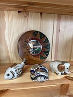 Wood shelf display of Tonala pottery animals and hand-carved wood mirror