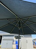 Opened umbrella showing blue canopy and brown metal frame
