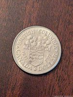 Reverse of the coin showing British Columbia shield and Pacific dogwood flowers with dates 1871-1971.