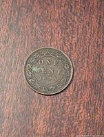 Reverse side of the 1896 Canadian one cent coin showing denomination and year with decorative border.