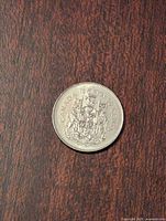 Image of the coin showing the Canadian coat of arms side with date 1991 and denomination 50 cents