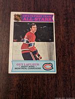 Front side of the 1975-76 O-Pee-Chee Guy Lafleur Montreal Canadiens hockey card showing player in uniform with text and logo.