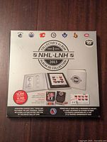 Front side of the unopened 2013 NHL Canada Post Collector's Album showing NHL logos and promotional details on a white background.