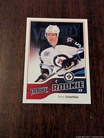 Front of 2011-12 Upper Deck Victory rookie card showing Mark Scheifele in Winnipeg Jets uniform with 'Victory Rookie' text, player name, and number 55.