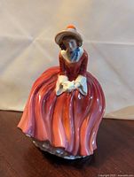 Front view of Royal Doulton Denise porcelain figurine showing detailed dress and bonnet