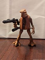 Front view of Momaw Nadon Hammerhead action figure holding a blaster with detailed features and brown vest.