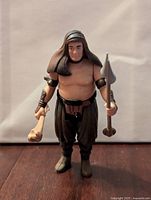 Front view of the Rancor Keeper Kenner Star Wars action figure holding spear and bone club.