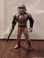 Front view of the figure wearing helmet, holding club weapon