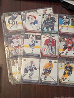 Three pages with 16 Upper Deck Rookie Class 2005-06 hockey cards in protective sheets showing multiple players from different NHL teams in various poses.