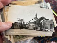 Real photo postcard of Menasha High School, Menasha, Wisconsin, featuring historical brick school building with clock tower.