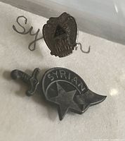 Two Scottish Rite pins; one eagle with '32' triangle and one Syrian star with sword.