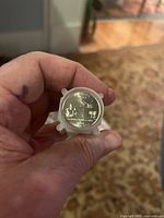 Roll of 2004 Florida state quarters with P mint mark, showing coin face with Florida state design in plastic wrap held in hand.