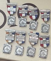 Full set of eight medals displayed on a surface; ribbons show red, white, and blue stripes; visible year bars and service bars.