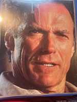 Close-up portrait image of Clint Eastwood's face, showing detailed facial lines and expression.