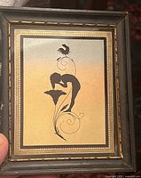 Framed art nouveau print with silhouette of pixie, flower, and rooster against gradient background.