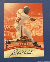Front of 1997 Donruss Signatures Rondell White autographed baseball card, showing player batting and signature on red-orange background.