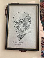 Front view of framed black and white portrait print of Octave Chanute with artist signature and dates.