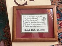 Front view of the framed print showing text and US Marines emblem with a wooden frame