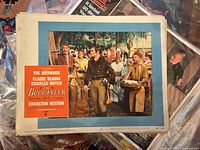 Lobby card for The Buccaneer showing characters in period costumes on plantation with title and actors listed