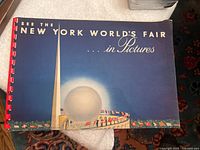 Front cover of the souvenir book featuring the Trylon and Perisphere with title text.