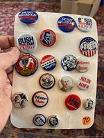 Front view showing 19 presidential campaign pins with various historical figures and campaign years.