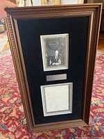 Framed item showing a black and white photo of Spiro Agnew above a faded replica letter with a certificate likely on the back.