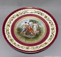 Front view of antique German Prov Saxe ES china shallow bowl or wall plate showing detailed painted central classical figures and ornamental border design