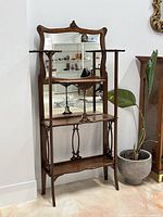 Full front view of Victorian hall tree showing mirror, shelves and overall form