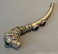 Front view of silver plated decorative pipe showing dragon design and green gemstone on bowl.
