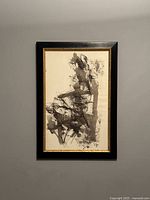 Full frontal view of framed ink and watercolor painting on wall