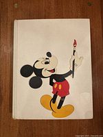 Front cover of the vintage book showing Mickey Mouse illustration holding a paintbrush.