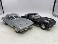 Front and side view of the black and gray Corvette Stingray Jim Beam decanters showing details and condition
