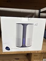 Photo of unopened Miko air purifier S model box showing full product image on front with LED control panel lit up and product name.