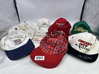 Front view of eight vintage snapback trucker caps showcasing various racing and sports logos in white, red, green, and plaid color schemes.