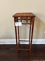Front view of the bamboo side table showing the full height and bamboo stalk style legs.